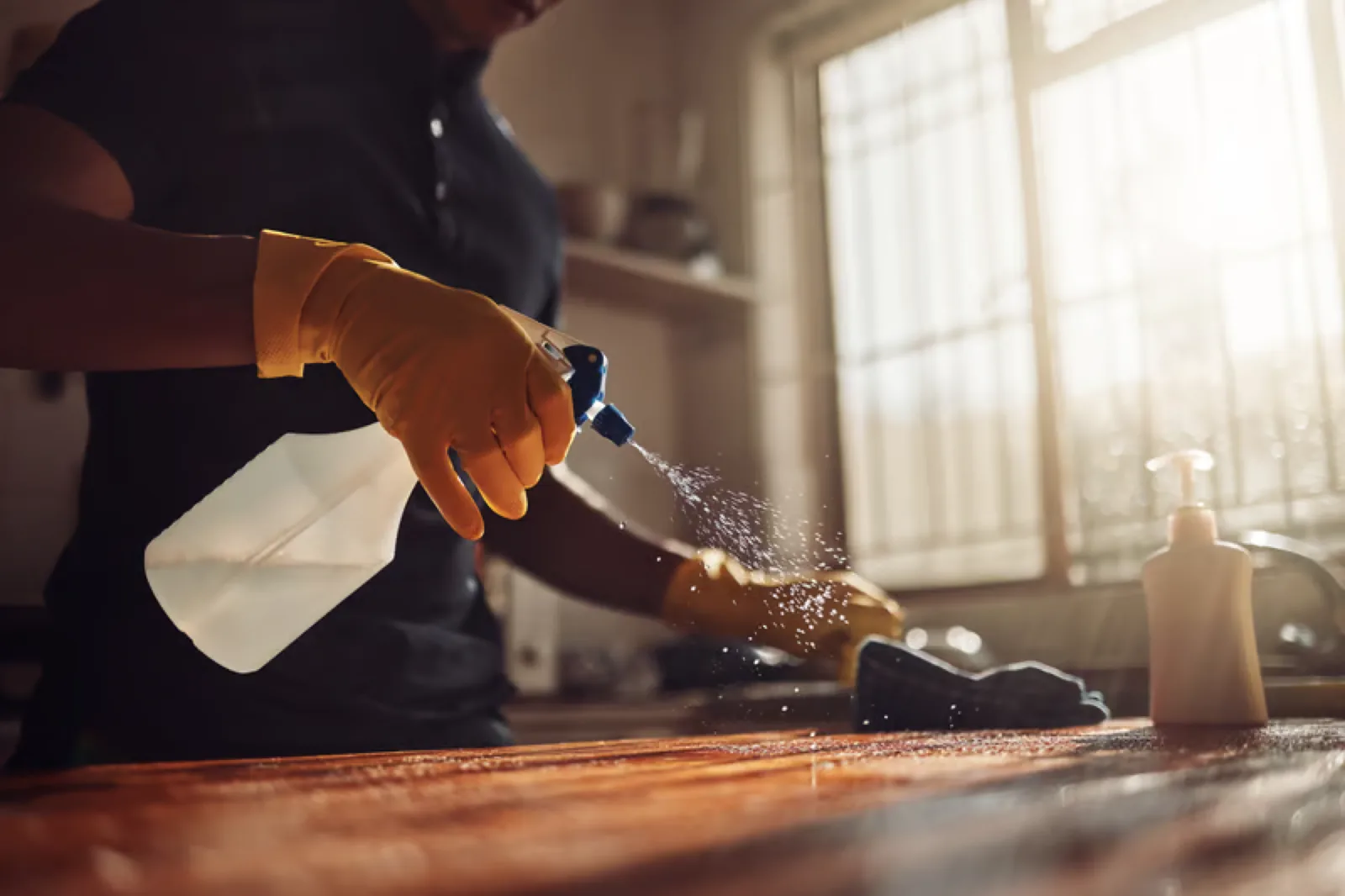 Professional cleaner wiping down an office surface