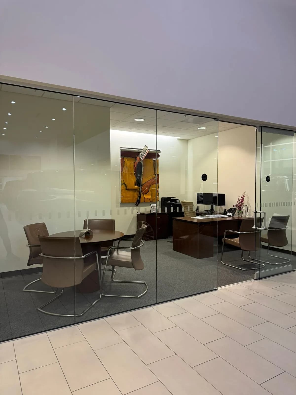 Clean private office with glass walls serviced by Empire