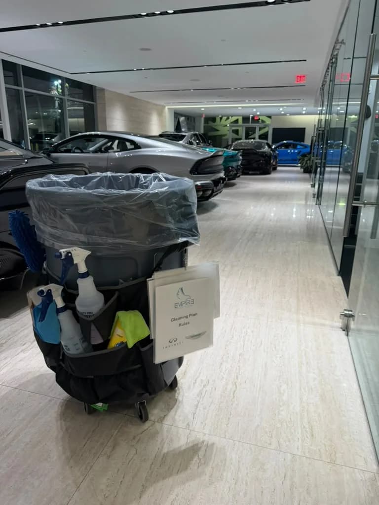 Empire Clean janitorial cart in a dealership hallway